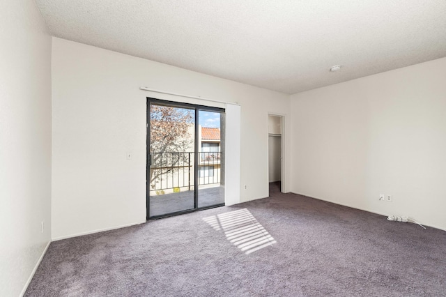 empty room featuring carpet floors and a textured ceiling