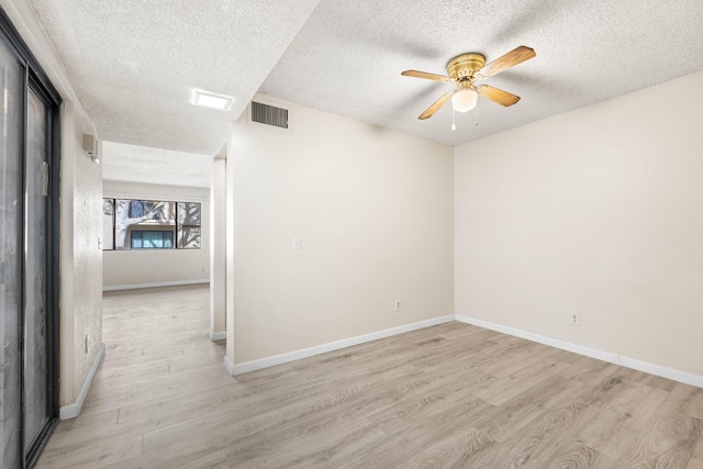 empty room featuring a textured ceiling, ceiling fan, and light hardwood / wood-style flooring