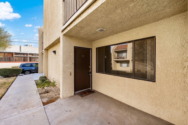 doorway to property featuring a patio