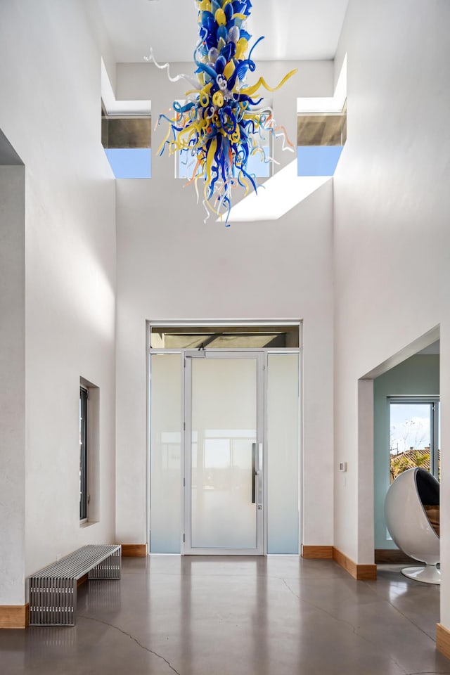 foyer entrance featuring a towering ceiling