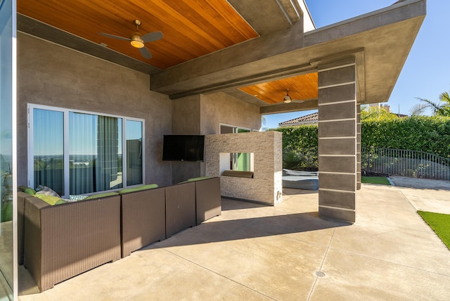 view of patio featuring a ceiling fan and fence