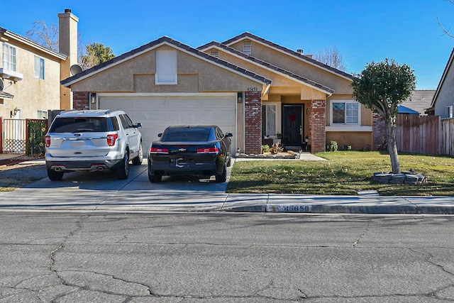 ranch-style house featuring a garage and a front yard