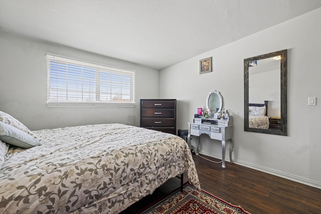 bedroom with dark wood-style floors and baseboards