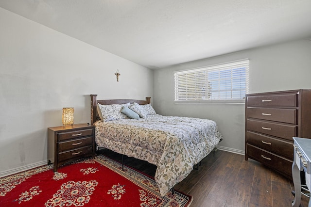 bedroom featuring dark wood finished floors and baseboards