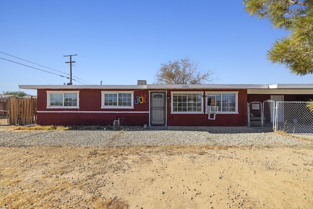 ranch-style house featuring a gate, fence, and cooling unit