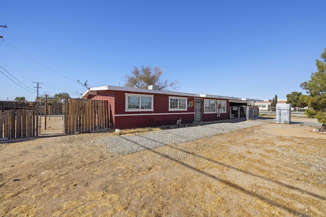 ranch-style house featuring a carport