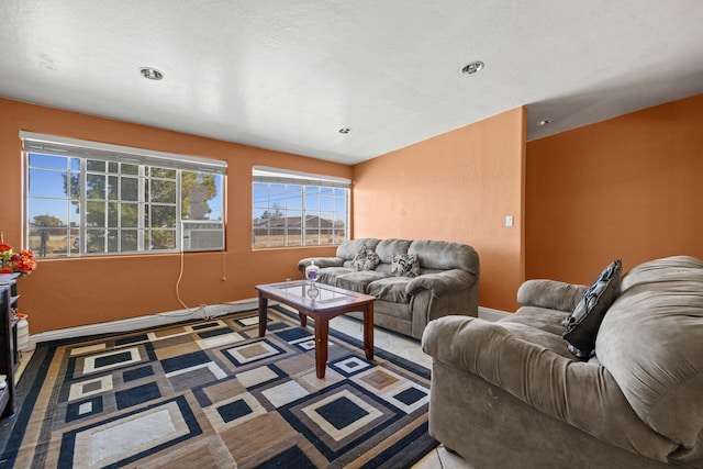 living room with cooling unit and baseboards