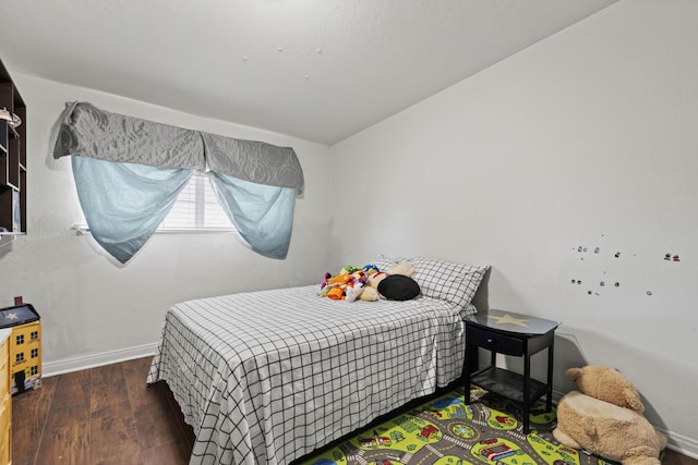 bedroom with dark hardwood / wood-style floors