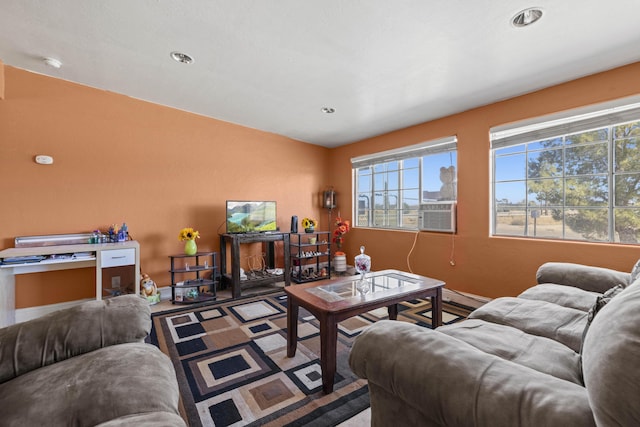 living area featuring baseboards and recessed lighting