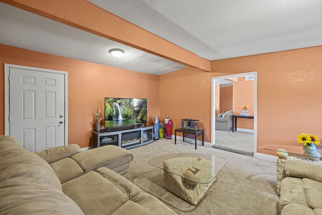 living area with a textured ceiling, a textured wall, carpet floors, baseboards, and beam ceiling