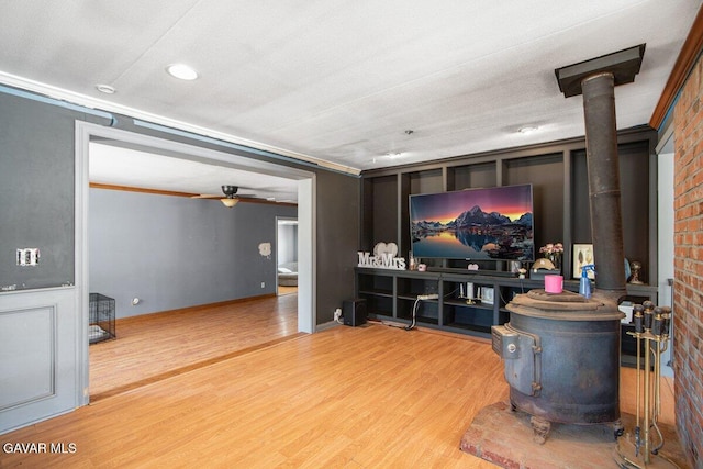 809 Berncastle Rd, Acton, CA 93510 - living room with a wood stove, wood finished floors, a ceiling fan, recessed lighting, and ornamental molding