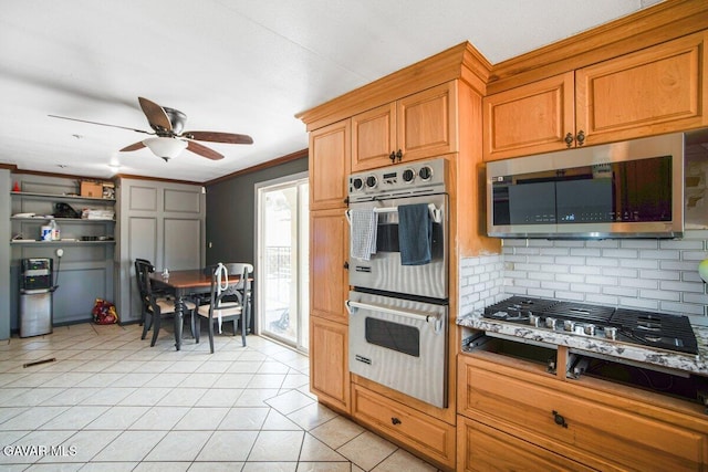 809 Berncastle Rd, Acton, CA 93510 - kitchen featuring stainless steel appliances, decorative backsplash, ceiling fan, light tile patterned floors, and crown molding