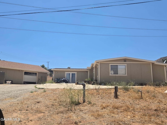 809 Berncastle Rd, Acton, CA 93510 - ranch-style home featuring a garage, driveway, and french doors