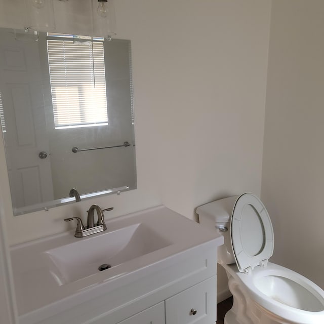 half bathroom featuring toilet and vanity