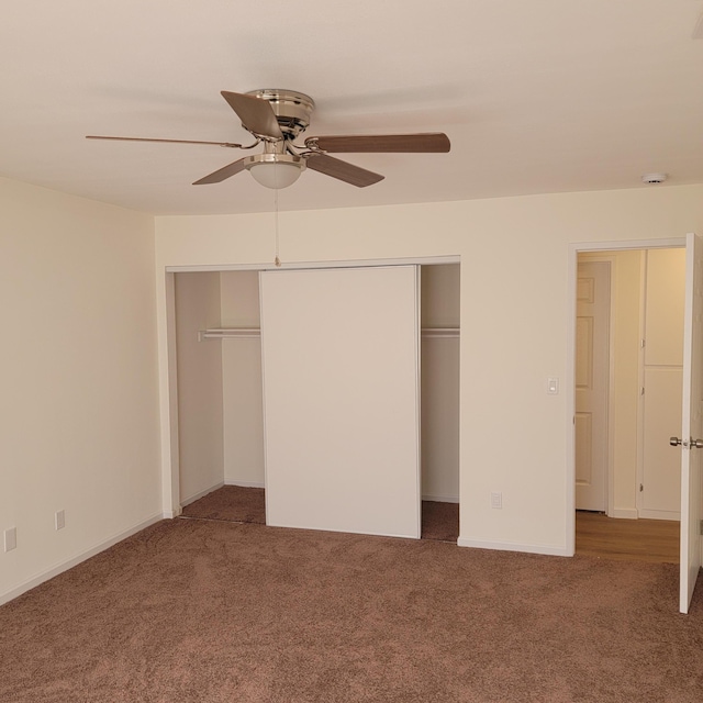 unfurnished bedroom with baseboards, carpet, a closet, and ceiling fan