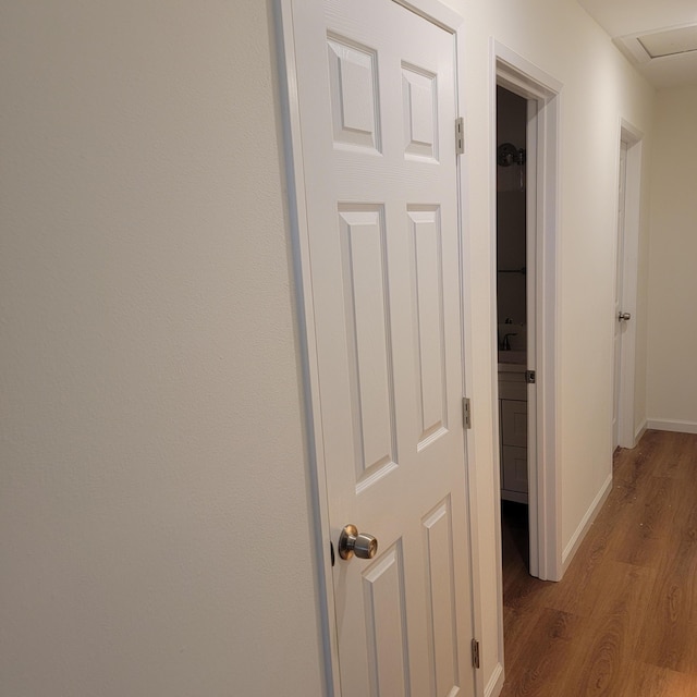 hallway featuring baseboards and light wood-type flooring