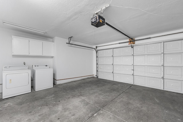 garage with washing machine and clothes dryer and a garage door opener