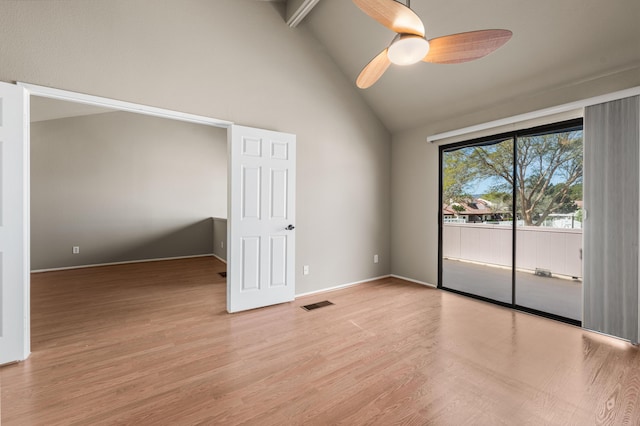 spare room featuring light wood-style flooring, high vaulted ceiling, baseboards, visible vents, and a ceiling fan