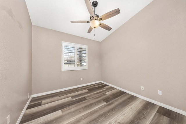 unfurnished room featuring vaulted ceiling, dark wood-type flooring, and ceiling fan