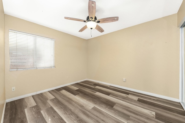 spare room with ceiling fan and wood-type flooring