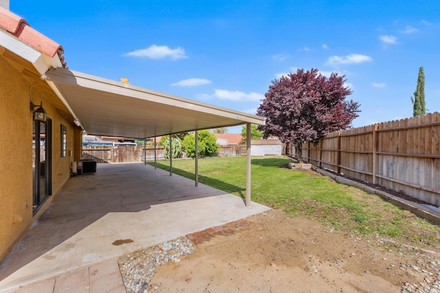 view of yard featuring a patio, a fenced backyard, and central air condition unit