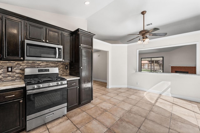 kitchen with ceiling fan, appliances with stainless steel finishes, light countertops, baseboards, and tasteful backsplash