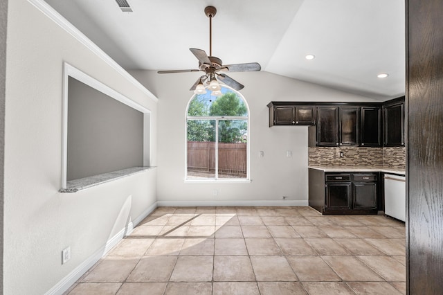 kitchen featuring white dishwasher, ceiling fan, light countertops, backsplash, and vaulted ceiling