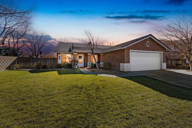 single story home featuring a lawn and a garage