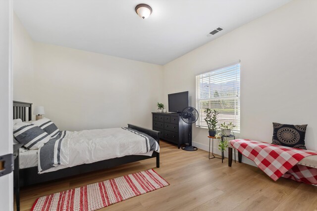bedroom with light wood-style flooring and baseboards