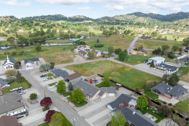 aerial perspective of suburban area featuring a water and mountain view