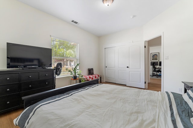 bedroom featuring wood finished floors and a closet