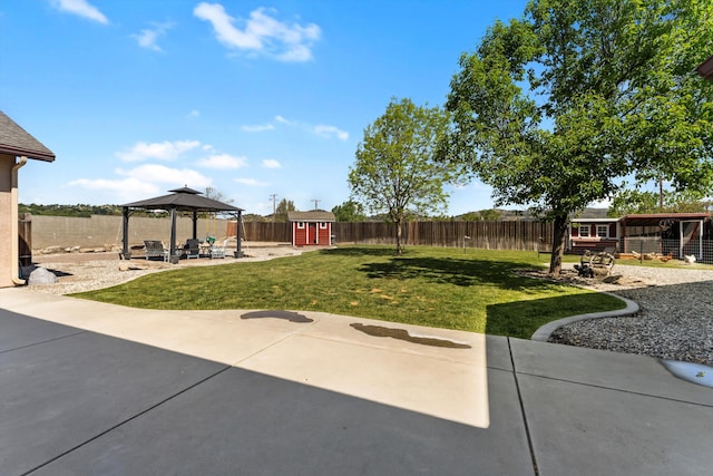 view of yard featuring a gazebo, an outdoor structure, a patio, and a storage shed