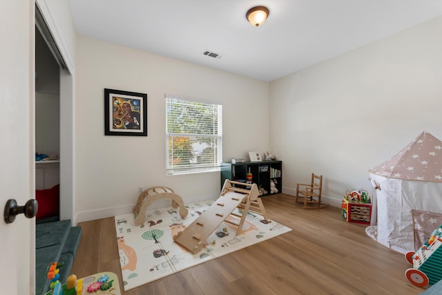 rec room featuring wood finished floors and baseboards