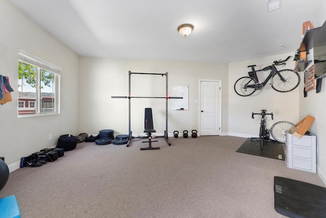 workout area with carpet flooring and baseboards