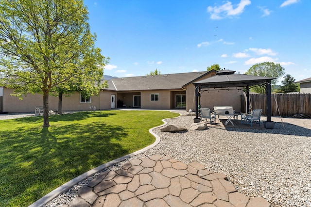 back of property featuring a gazebo, a patio area, and stucco siding