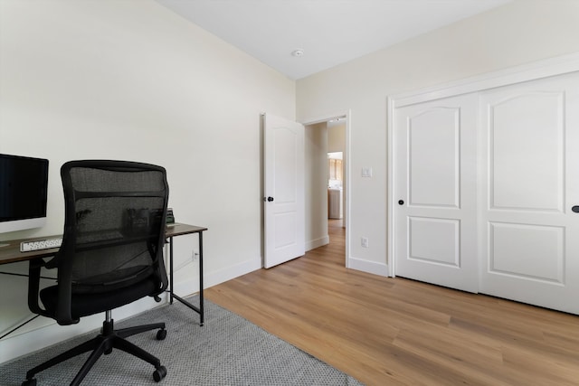 office featuring light wood-style flooring and baseboards