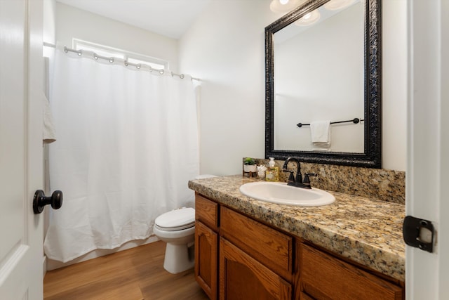bathroom with toilet, vanity, wood finished floors, and a shower with shower curtain