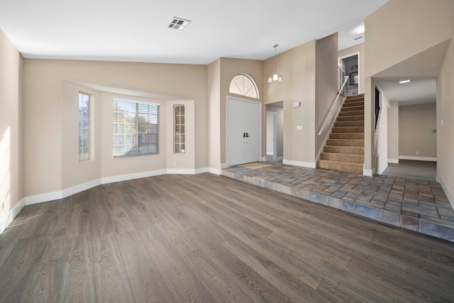 entrance foyer featuring dark hardwood / wood-style floors and lofted ceiling