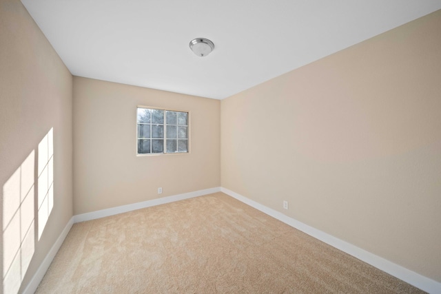 spare room featuring light colored carpet