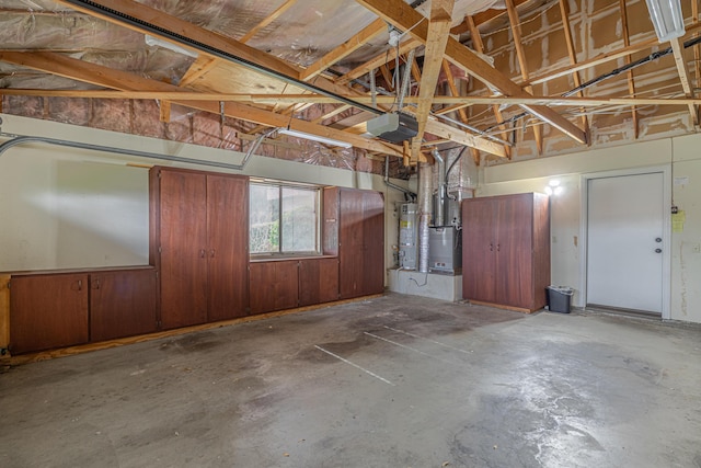 garage featuring water heater and a garage door opener