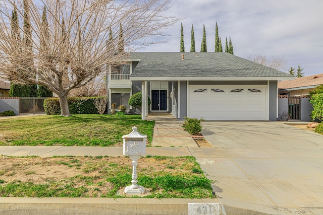 view of front of property featuring roof with shingles, concrete driveway, an attached garage, a front yard, and fence