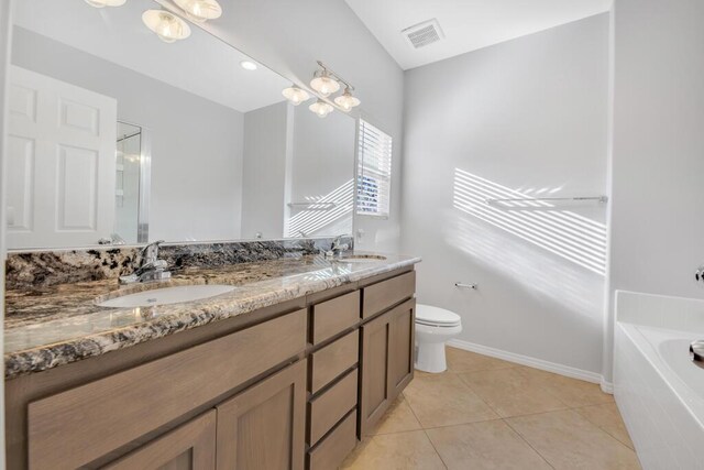 bathroom featuring a relaxing tiled tub, a notable chandelier, tile patterned floors, toilet, and vanity