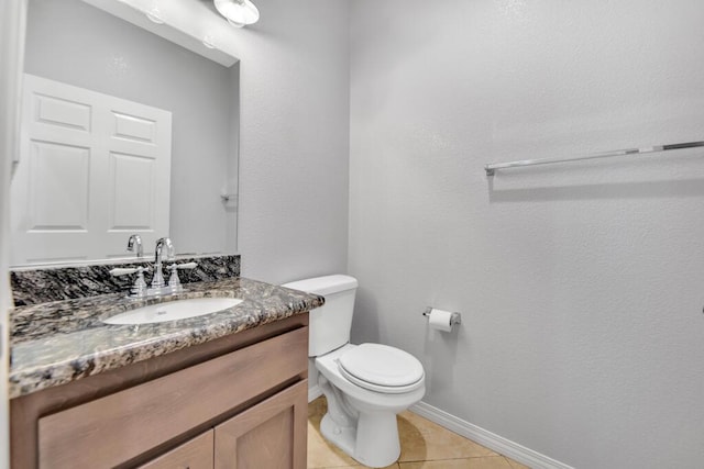 bathroom with tile patterned floors, vanity, and toilet