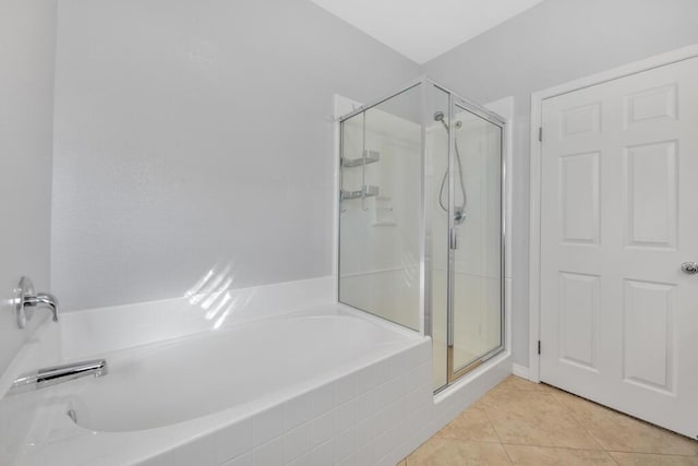 bathroom with tile patterned floors and an enclosed shower