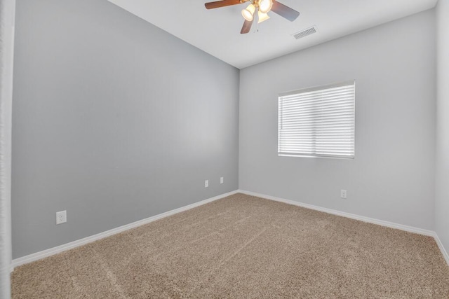 carpeted spare room featuring ceiling fan