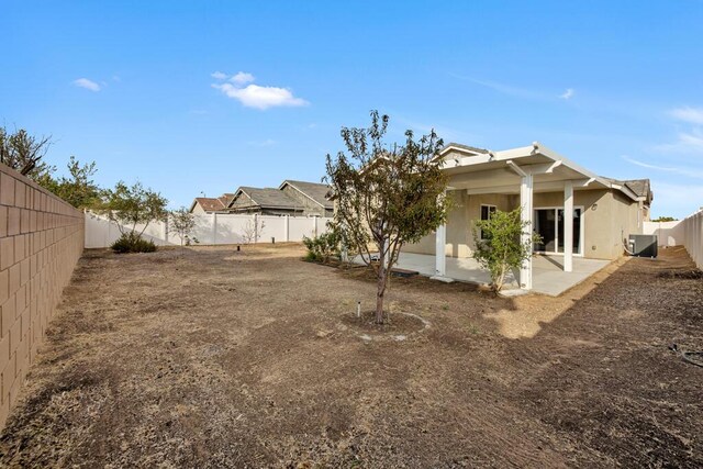 back of house with central air condition unit and a patio