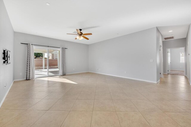 tiled empty room featuring ceiling fan