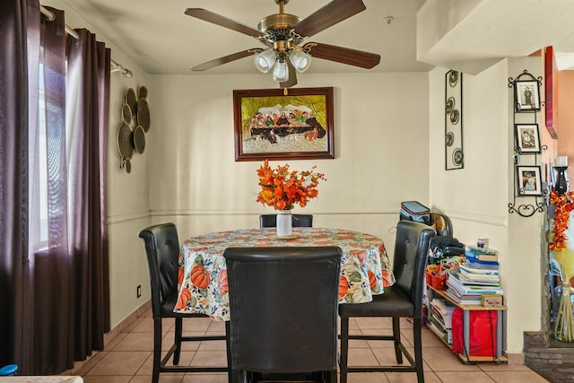 tiled dining area with ceiling fan