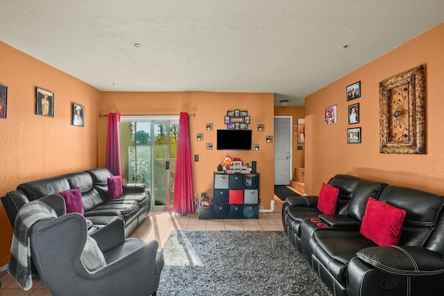 tiled living room featuring a textured ceiling