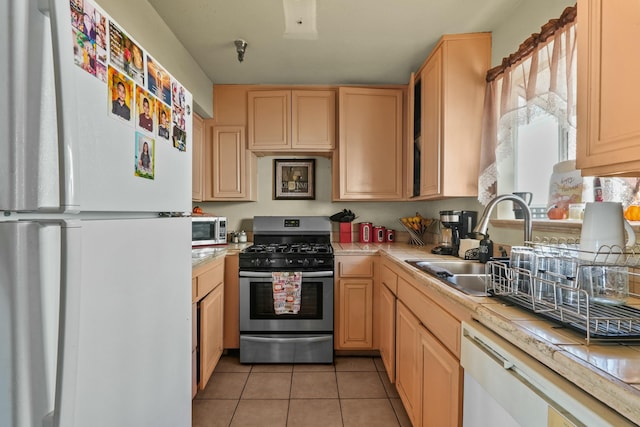 kitchen featuring tile countertops, light brown cabinetry, light tile patterned floors, and stainless steel appliances